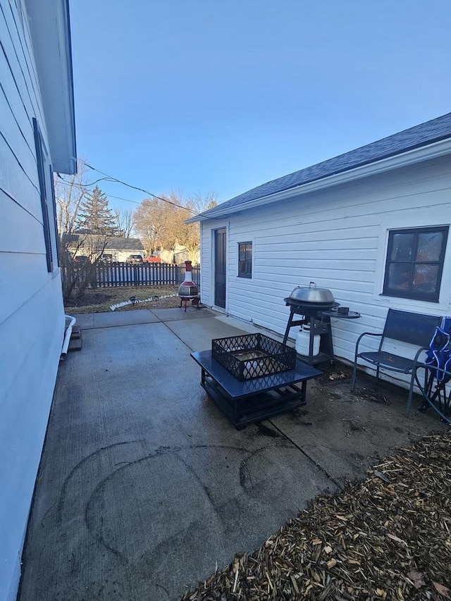 view of patio with fence, a fire pit, and grilling area