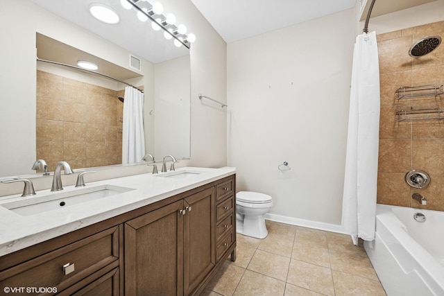 bathroom with toilet, baseboards, a sink, and tile patterned floors