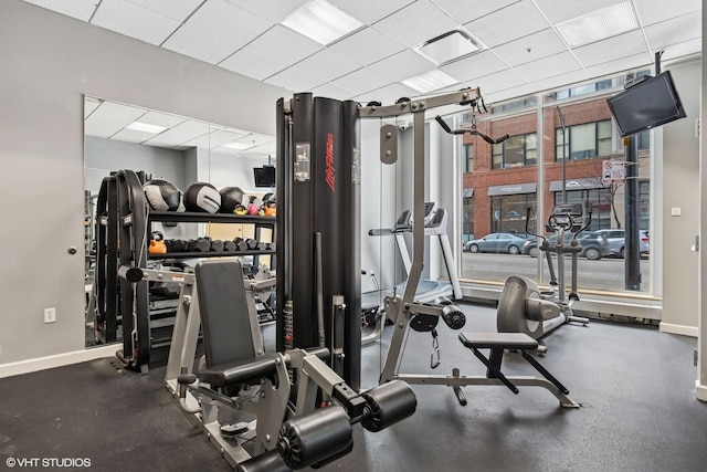 exercise room with visible vents, baseboards, and a drop ceiling