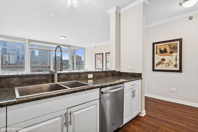 kitchen with a view of city, crown molding, dark countertops, a sink, and dishwasher