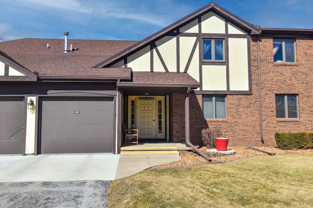 tudor house with brick siding, stucco siding, a shingled roof, an attached garage, and driveway