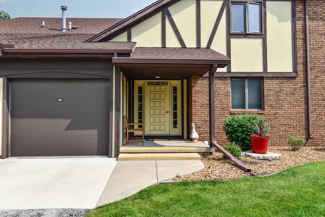 208 Carol Ct Unit A2, Pontiac, IL 61764 - entrance to property featuring concrete driveway, an attached garage, brick siding, a shingled roof, and stucco siding