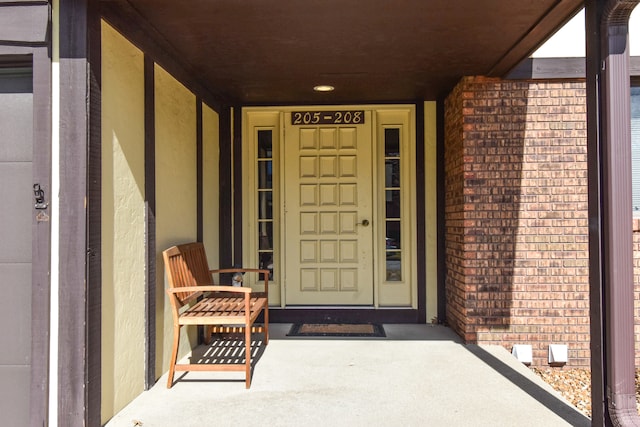 view of exterior entry with brick siding