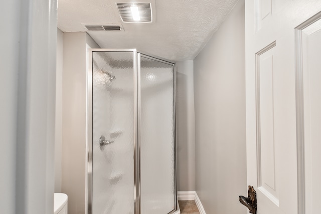 208 Carol Ct Unit A2, Pontiac, IL 61764 - bathroom featuring a shower stall, toilet, and baseboards