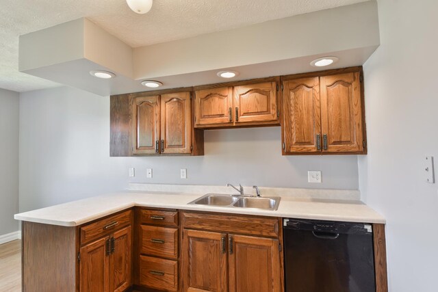 208 Carol Ct Unit A2, Pontiac, IL 61764 - kitchen featuring black dishwasher, a sink, light countertops, a peninsula, and brown cabinetry