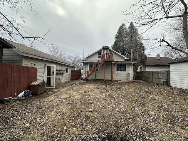 back of house with fence and stairway