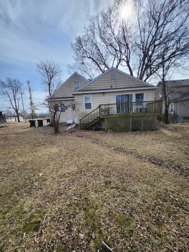 rear view of house featuring a wooden deck