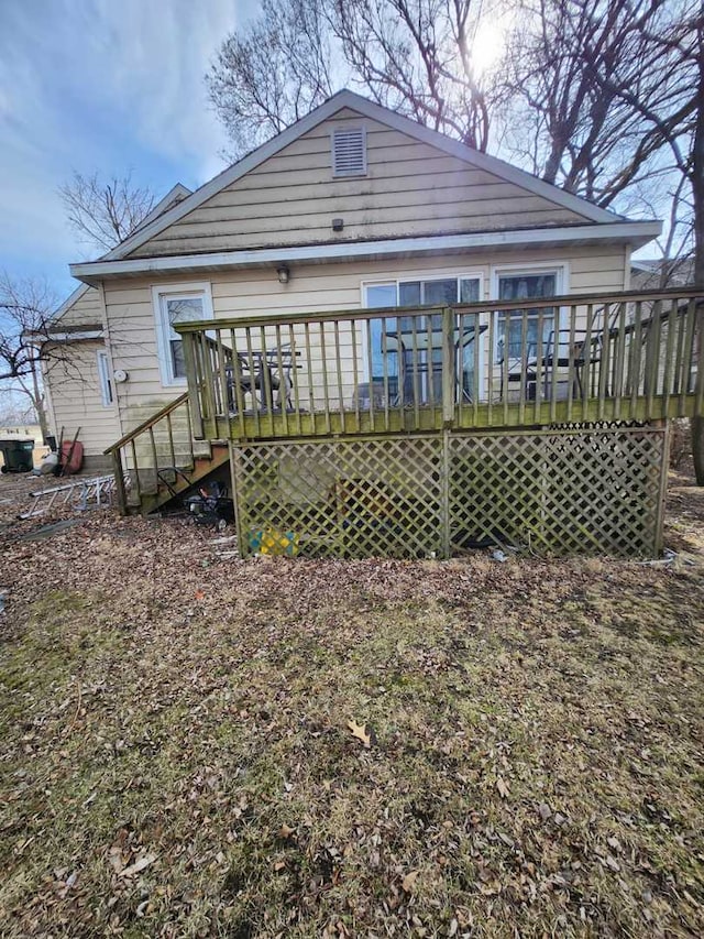 back of house featuring a deck