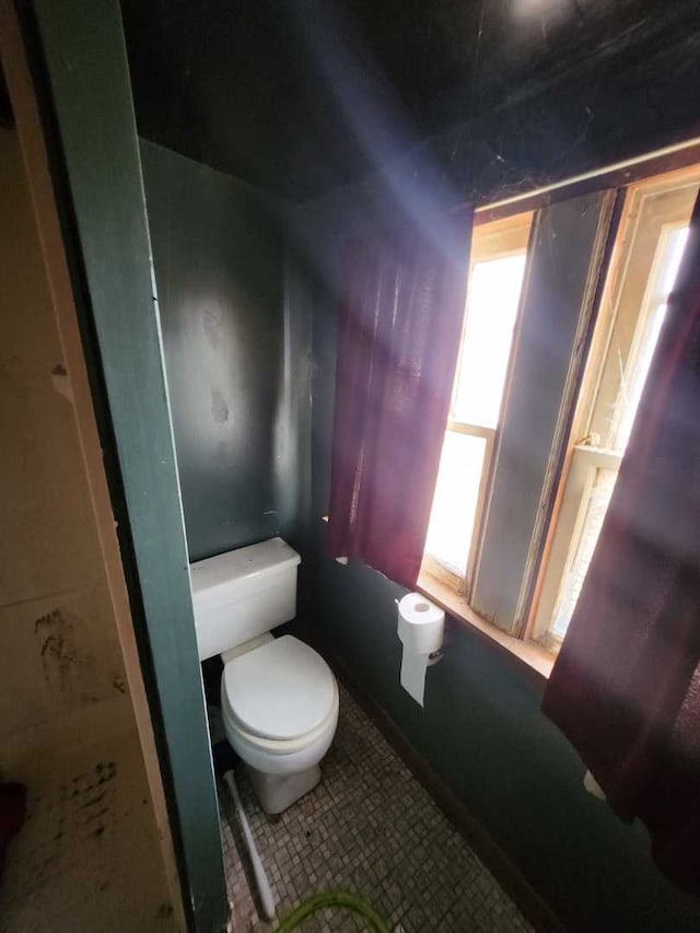 bathroom featuring toilet and tile patterned floors