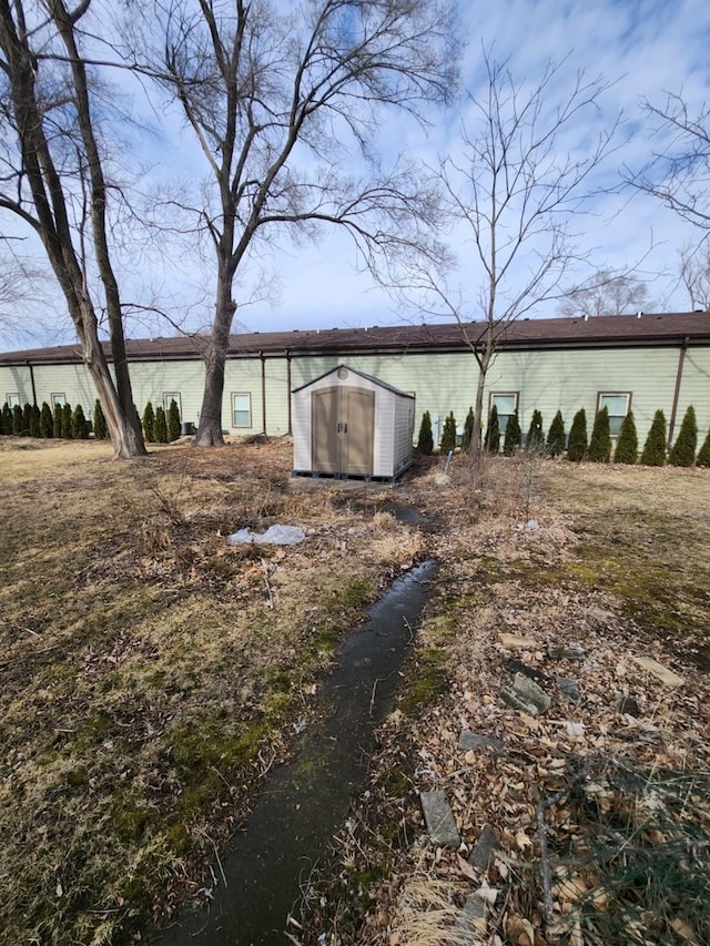 view of side of home featuring an outbuilding and a storage unit