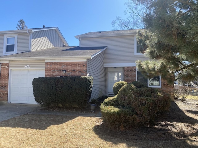 view of front of house featuring brick siding and an attached garage