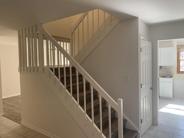 staircase with tile patterned floors and baseboards