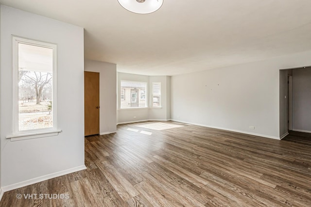 unfurnished room with wood finished floors and baseboards