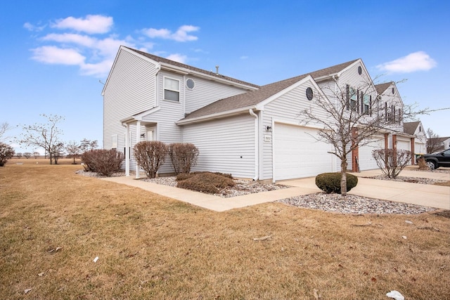 view of side of home with concrete driveway, a yard, and an attached garage