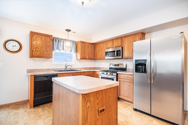 kitchen featuring appliances with stainless steel finishes, light countertops, a sink, and hanging light fixtures