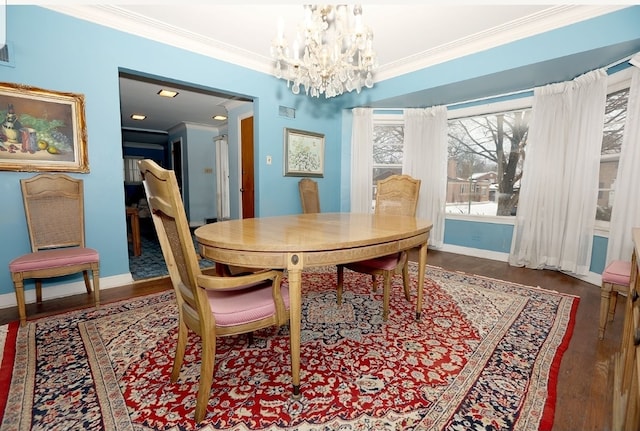 dining area with crown molding, baseboards, and wood finished floors