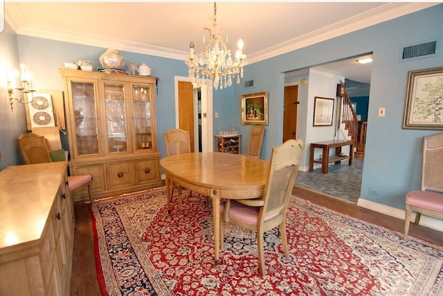 dining space featuring visible vents, ornamental molding, stairway, and wood finished floors