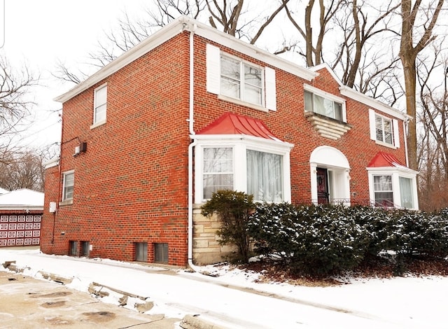 view of front of home with brick siding and central air condition unit