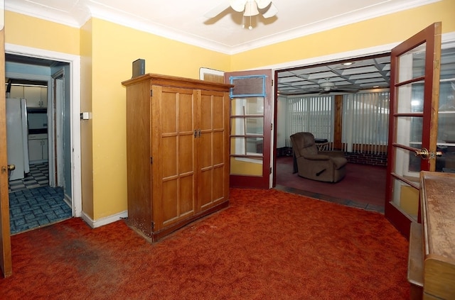 interior space with carpet flooring, french doors, baseboards, and ornamental molding