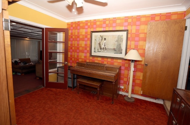 sitting room with wallpapered walls, crown molding, and carpet