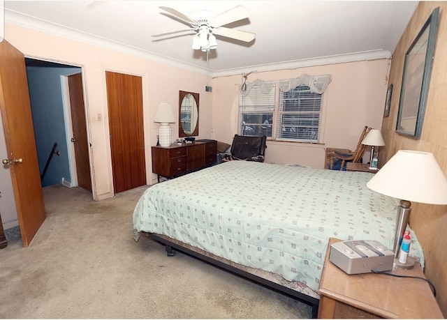 bedroom with carpet flooring, ceiling fan, and ornamental molding