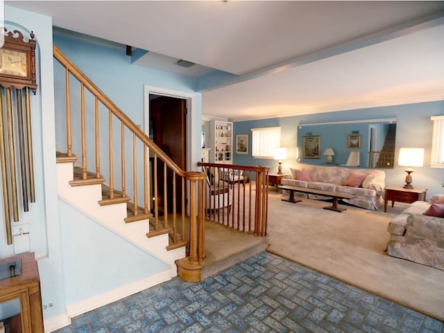 staircase featuring brick floor, carpet flooring, visible vents, and baseboards