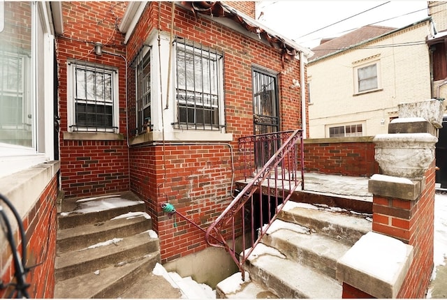 doorway to property featuring brick siding