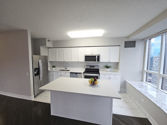 kitchen with marble finish floor, visible vents, appliances with stainless steel finishes, and light countertops