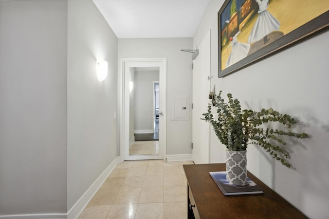 interior space featuring light tile patterned flooring and baseboards