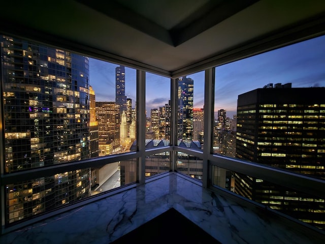 unfurnished sunroom with a city view