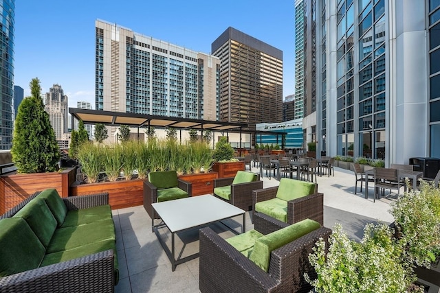 exterior space featuring a view of city, outdoor dining area, and an outdoor living space