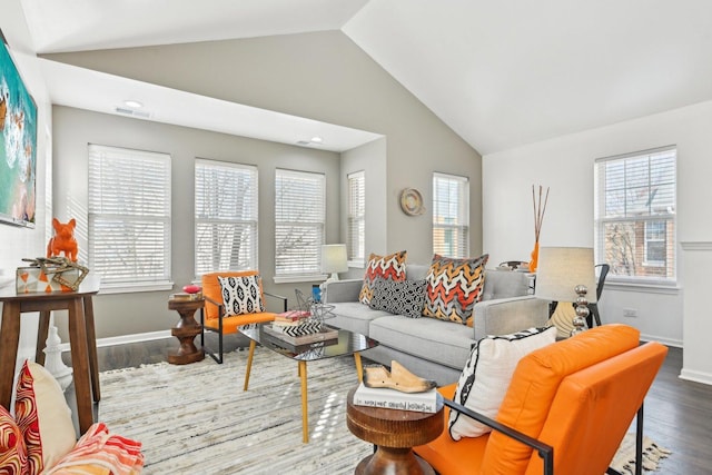 living area featuring a wealth of natural light, baseboards, lofted ceiling, and wood finished floors