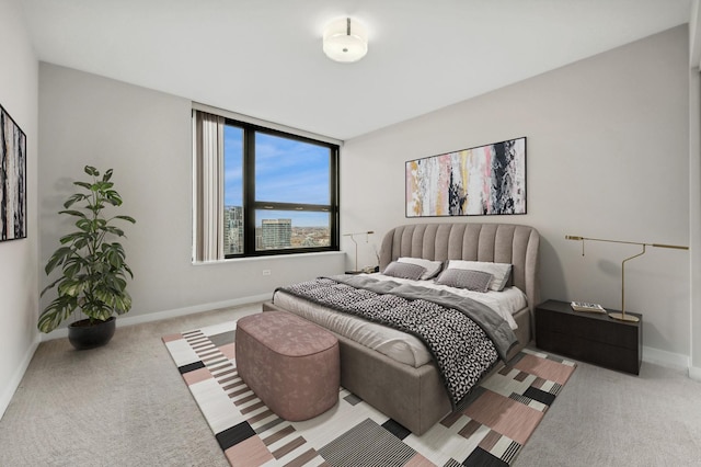 bedroom featuring light carpet and baseboards