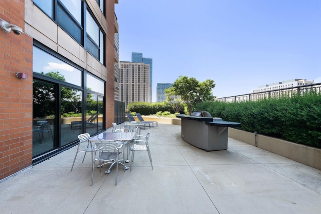 view of patio featuring a view of city and outdoor dining area