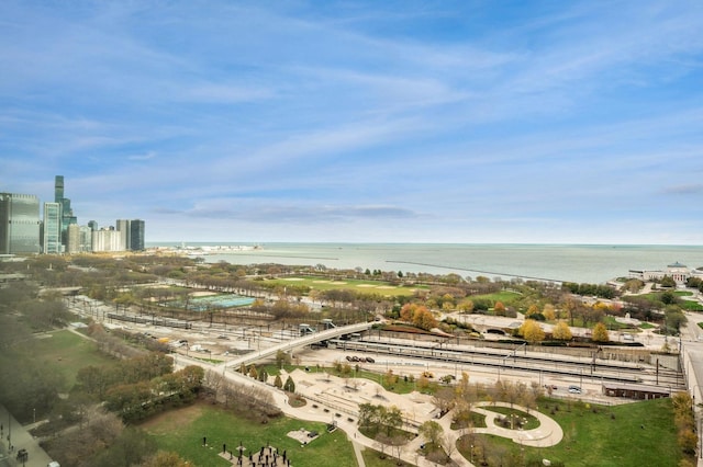 birds eye view of property with a water view and a view of city