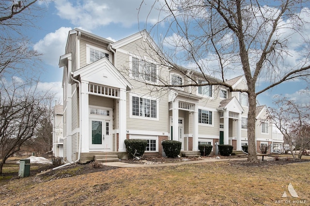 view of front of house featuring entry steps and brick siding