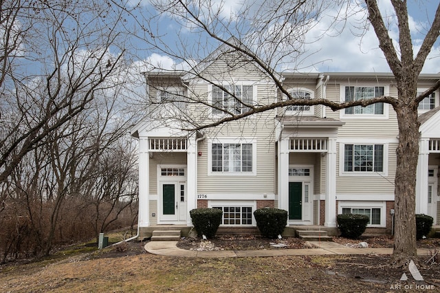 view of front of home with entry steps and brick siding