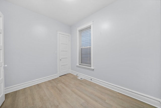 3323 N Central Park Ave, Chicago, IL 60618 - empty room featuring light wood-style floors, visible vents, and baseboards