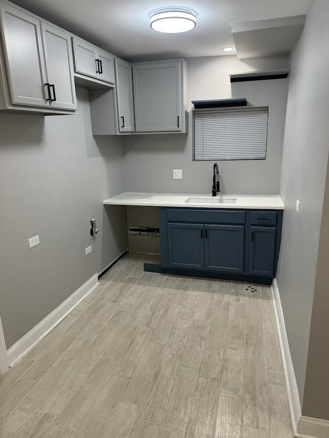 3323 N Central Park Ave, Chicago, IL 60618 - kitchen with a sink, baseboards, light wood finished floors, and light countertops