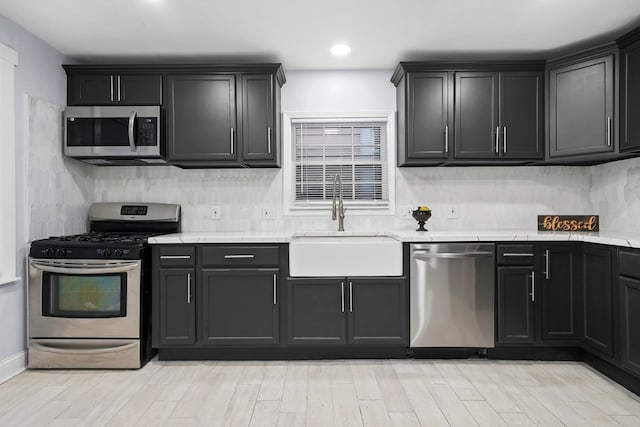 3323 N Central Park Ave, Chicago, IL 60618 - kitchen featuring a sink, stainless steel appliances, tasteful backsplash, and light wood-type flooring