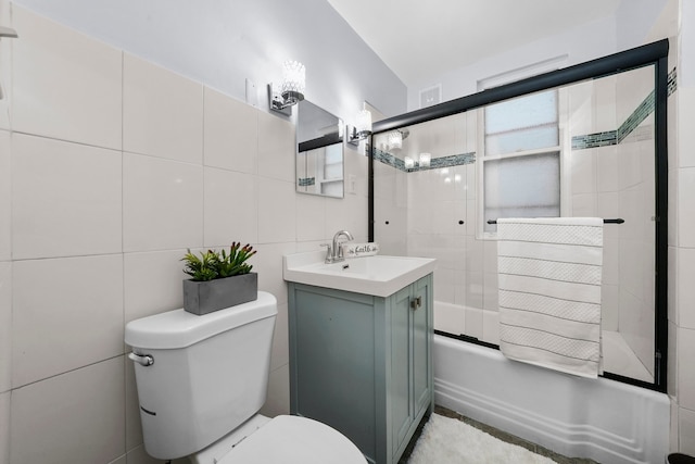 3323 N Central Park Ave, Chicago, IL 60618 - bathroom with toilet, shower / bath combination with glass door, tile walls, visible vents, and vanity