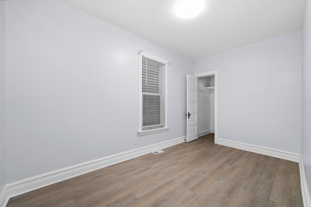 3323 N Central Park Ave, Chicago, IL 60618 - unfurnished bedroom featuring baseboards, a closet, visible vents, and wood finished floors