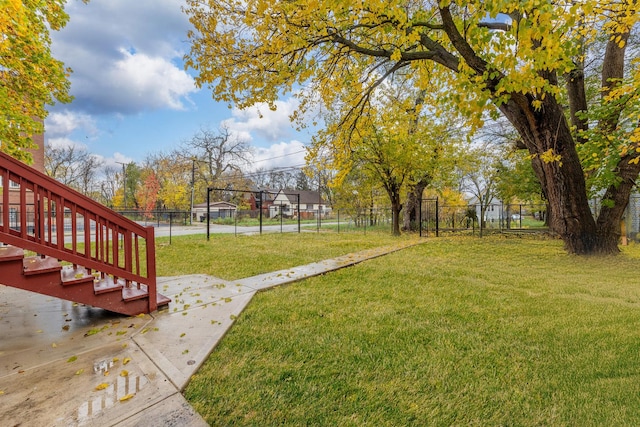 view of yard with stairs and fence