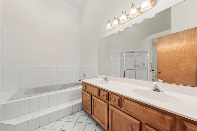 full bathroom with a stall shower, tile patterned flooring, a garden tub, and a sink