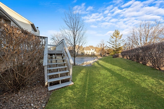 view of yard with a water view and stairway