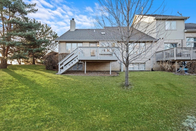 rear view of property with a deck, a yard, a chimney, and stairs