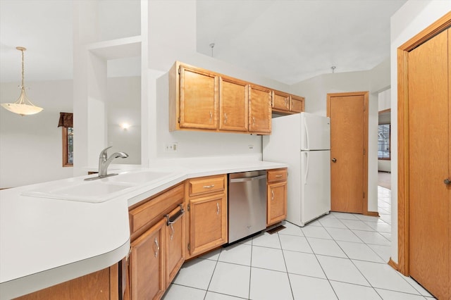 kitchen with light tile patterned floors, dishwasher, decorative light fixtures, freestanding refrigerator, and light countertops