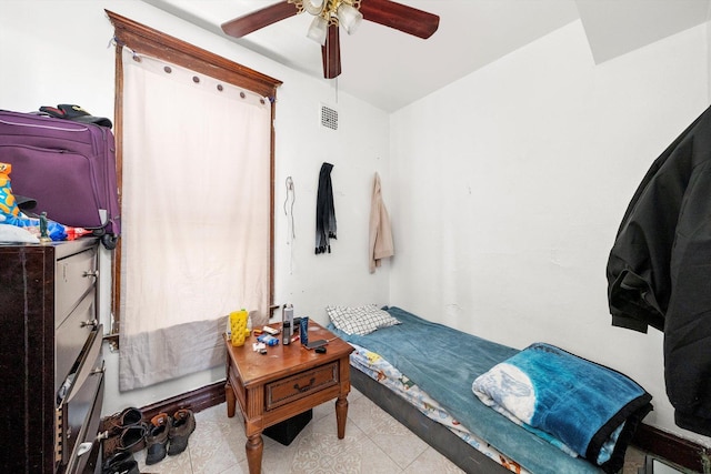 bedroom with a ceiling fan, visible vents, and light tile patterned flooring