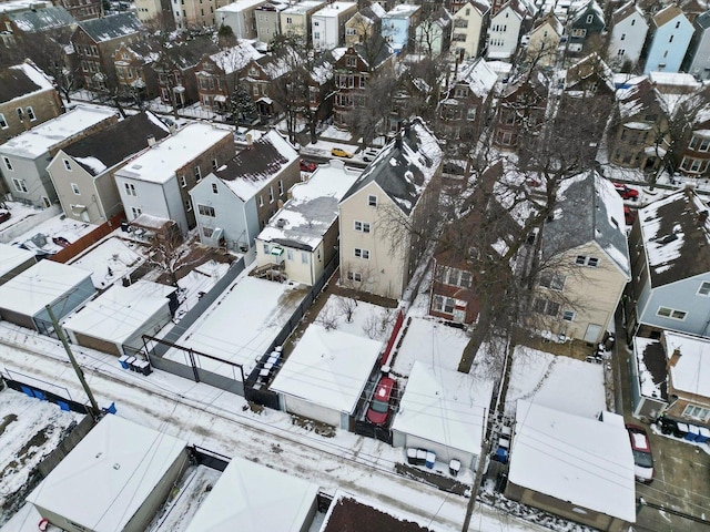 snowy aerial view featuring a residential view