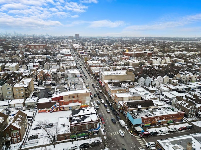 snowy aerial view with a city view